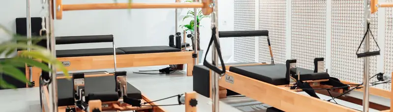 木枠のマシンが並ぶ、白いスタジオの床ぎわ